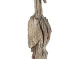 wooden sculpture of a pelican standing on a piece of wood