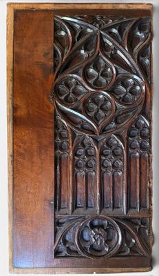 an old wooden panel with a carved design on it