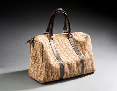 an image of a brown and black handbag on a gray surface