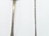 two spoons that are sitting next to each other