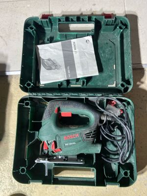 a green box with tools in it sitting on the floor