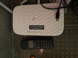 a remote and a cell phone sitting on a table