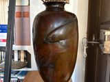 a vase with branches in it sitting on a wooden table