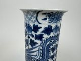 a blue and white vase sitting on a table
