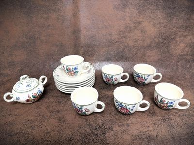 a group of cups and saucers on a table