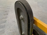 a close up of a wheel on a yellow cart