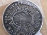 an old silver coin with a picture of a train on it