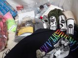 a pile of clothing and other items that are on a bed