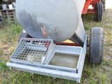 an image of a cement mixer sitting on top of a grass covered field