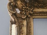 a picture of a gold frame on the wall