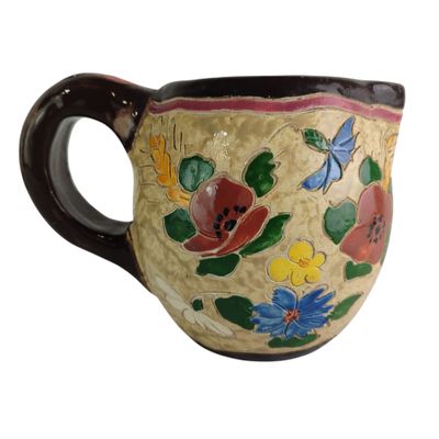 a coffee cup with a floral design on it