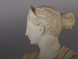 marble bust of a woman with a bun on her head