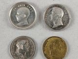 three different types of coins sitting on top of a white surface
