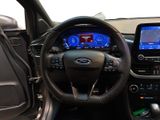 a steering wheel and dashboard of a car with a touch screen
