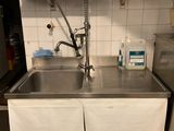 a kitchen with a sink and a refrigerator in it