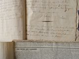 an old book with a page of writing on it sitting on top of a table