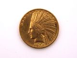 a close up of a gold coin on a white surface