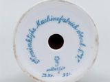 an old white porcelain vase with a blue writing on it