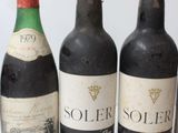 several bottles of wine are lined up on a white surface