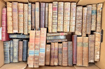 a box full of old books sitting on the floor