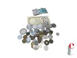 a pile of coins and a bank note on a table