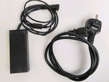 a black power cord and a charger on a white surface