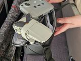 a person that is holding a remote control in a bag
