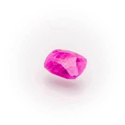 a close up of a pink diamond on a white surface