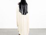 the statue of a woman in a black and white robe is standing on a pedestal