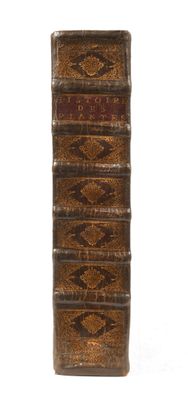 a close up of a stack of books on a white surface