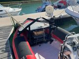 a red and black boat parked at a dock