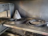 a metal shelf with plates and a cone on it