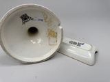 a white vase with a black and white design on it