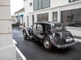 a black car that is parked on the side of the street