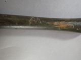 a baseball bat that has been scratched and is on the table