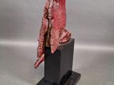 statue of a red dragon on a black base