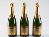three bottles of champagne on a white background