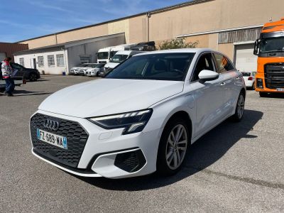 a white car parked in a parking lot with a truck in the background