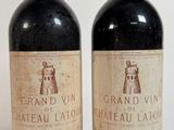 deux bouteilles de vin rouge posées l'une à côté de l'autre sur une surface blanche