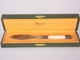 a small knife in a box on a table