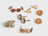 several pairs of earrings are arranged in a circle on a white surface