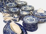 a lot of blue and white plates and bowls on the table
