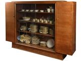 a cabinet that has many plates and bowls in it