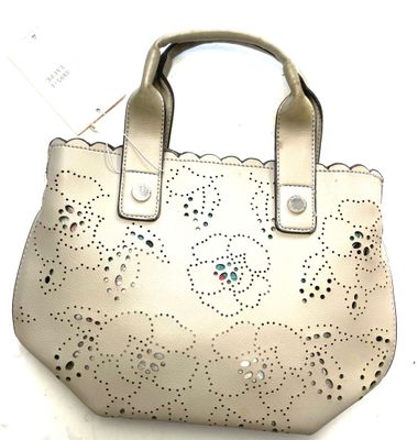 a white purse that is sitting on a table
