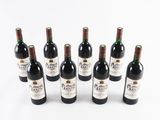 six bottles of wine are lined up in a row on a white surface
