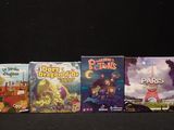 several children ' s board games are lined up on a black surface
