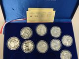a blue box with six silver coins in it