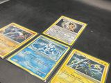 a lot of pokemon cards on the table
