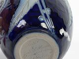 a blue vase with a dragonfly design on it