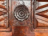 a close up of a wooden door with a decorative design on it